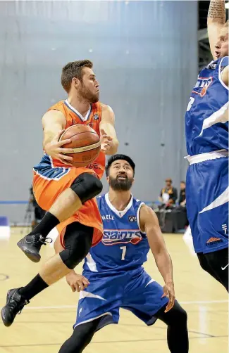  ?? PHOTO: ROBYN EDIE/FAIRFAX NZ ?? Sharks player Mitch Norton puts a shot up watched by Saints players Damien Ekenasio and Joshua Duinker, right, in Invercargi­ll last night.