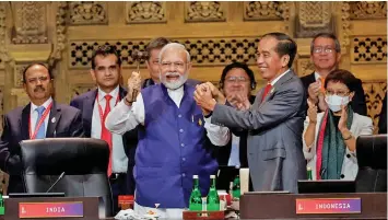  ?? Photo: CNN ?? India’s Prime Minister Narendra Modi and Indonesia’s President Joko Widodo hold hands during the handover ceremony at the G20 leaders’ summit, in Nusa Dua, Bali, Indonesia on November 16, 2022.