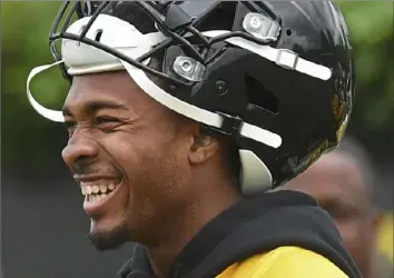  ?? Peter Diana/Post-Gazette ?? Steelers cornerback Justin Layne goes through drills during minicamp Thursday at the UPMC Rooney Sports Complex. Steelers rookie Justin Layne and his father, Deondre Layne, in an undated photo. Deondre had been a lifelong Cleveland Browns fan, until his son was drafted by perhaps their biggest rival.