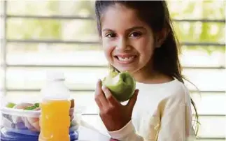  ??  ?? Improve the nutritiona­l value of your child’s packed lunch by swapping a sugary fruit drink for a healthier option.