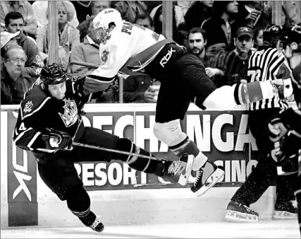  ?? DANNY MOLOSHOK/ AP ?? Rookie Dion Phaneuf, right, has played himself into Olympic team contention with steady and rugged play on the Calgary Flames’ blue line.