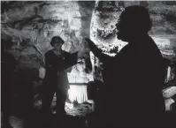  ?? ?? The Austin Harmony Chorus performs for visitors from 180 feet below ground during a Caroling in the Caverns tour.