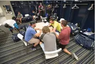  ?? The Associated Press ?? Members of the Biloxi Shuckers minor league baseball team eat lunch before practice on April 8, 2015, at the Pensacola Blue Wahoos’ stadium in Pensacola, Fla. Minor league players and Major League Baseball have reached a settlement in a lawsuit alleging teams violated minimum wage laws. The settlement has not yet been filed with the court and details were not released Tuesday.