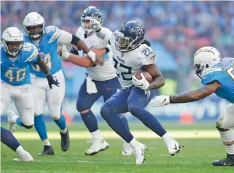  ?? AP PHOTO/MATT DUNHAM ?? Tennessee Titans running back Derrick Henry carries the ball during a game against the Los Angeles Chargers in October 2018 at Wembley Stadium. The Titans lost 20-19 that day in their first regular-season game in London, but they’ll return to the city this year to play at Tottenham Hotspur Stadium.