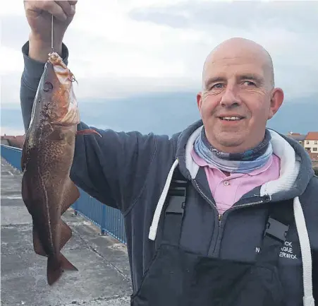  ?? ?? Alan Brown with a fish caught off Dunbar Harbour. Picture: Nigel Duncan