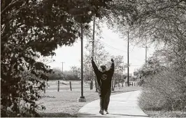  ?? Lisa Krantz / Staff photograph­er ?? Baca stretches as he walks in Kardon Park near his home. He is working to regain his strength so he can sing again.