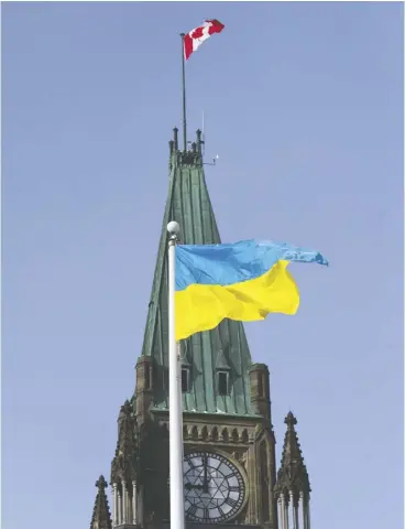  ?? Pat mcgrath / Postmedia news FILES ?? A Ukrainian flag is flown on Parliament Hill in 2014 to demonstrat­e the Canadian government’s solidarity with the people of Ukraine.
