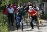  ?? — PTI ?? Kashmiri students throw stones at police personnel men as they clash in Srinagar on Monday.