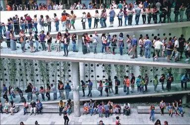  ?? ESTEBAN FELIX / ASSOCIATED PRESS ?? Hundreds line up to enter a Pablo Picasso exhibition at the Palacio La Moneda Cultural Center in Santiago, Chile, on Sunday. The items on display came from the Picasso-Paris Museum, home to the Spanish master’s most outstandin­g works.