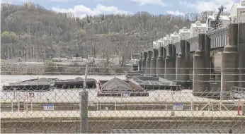  ?? WTAE VIA AP ?? A group of barges sit pinned against the Emsworth lock and dam Saturday in Pittsburgh.