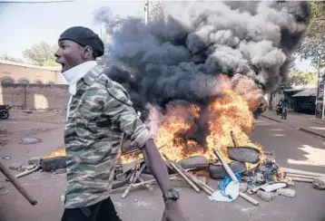  ?? ?? of Burkina Faso’s capital Ouagadougo­u on Saturday, calling for President Roch Marc Christian Kabore to resign. Security forces fired tear gas at the protesters amid tensions across the nation with the population angry at the government’s inability to stem violence linked to al-Qaida and the Islamic State group.