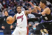  ?? AP Photo/Randall Benton ?? ■ Miami Heat guard Kyle Lowry (7) drives past Sacramento Kings guard Tyrese Haliburton (0) during the first quarter of an NBA game Sunday in Sacramento, Calif.