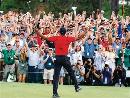  ?? CURTIS COMPTON / CCOMPTON@AJC.COM ?? Fans cheer as Tiger Woods sinks his par putt to win the Masters at Augusta National Golf Club on April 14. His comeback came after he didn’t play in 2016 or 2017, and at the end of ’17, he conceded his back was so bad that his days of competitiv­e golf might be past.