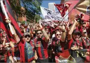  ??  ?? Atlanta fans yell and wave flags outside the stadium before Saturday’s game. it was the team’s finale at Grant Field before moving into Mercedes-Benz Stadium.