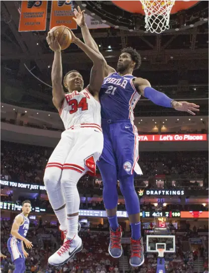  ?? CHRIS SZAGOLA/AP ?? Rookie big man Wendell Carter Jr. had a tough time with 76ers star Joel Embiid in the Bulls’ season opener Thursday.