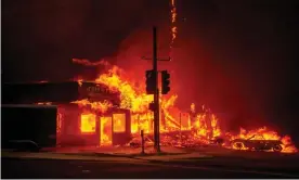  ?? Photograph: Josh Edelson/AFP/Getty Images ?? A store burns as the Camp fire tears through Paradise, California.