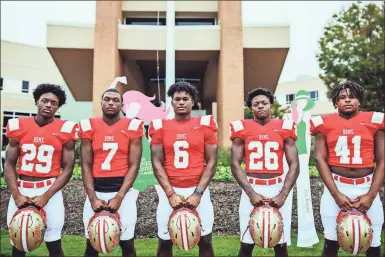  ?? / Rome City Schools ?? Rome High football players Jamar Roberts (from left), Xavier Roberts-Donaldson, Jamious Griffin, Marquis Glanton and Derricus Smith stand at the entrance to Floyd Medical Center, home to The Breast Center at Floyd. The team helped raise money for the center and played a Pink Out Game on Friday to promote breast cancer awareness.