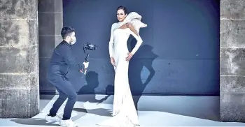  ?? — AFP photo ?? A model presents a creation by French designer Stephane Rolland during the shooting of a film designed to replace Haute Couture fashion shows in Paris during the Covid-19 pandemic.