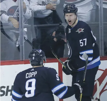  ?? KEVIN KING ?? Winnipeg Jets defenceman Tyler Myers celebrates his goal with Andrew Copp during Game 2 against the Minnesota Wild Friday in Winnipeg. The Jets went on to record a 4-1 victory to take a 2-0 lead in the best-of-seven series, which shifts to St. Paul,...