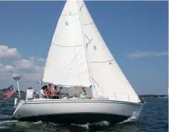  ??  ?? The Davis family crew, aboard their Ericson 34, Moondance, look fast as they beat their way upwind.