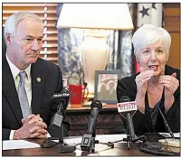  ?? Arkansas Democrat-Gazette/THOMAS METTHE ?? Gov. Asa Hutchinson and state Department of Human Services Director Cindy Gillespie discuss shrinking Medicaid rolls and costs at a news conference Thursday at the state Capitol.