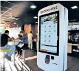  ?? ?? Self-service kiosks are increasing­ly common in British fast-food outlets