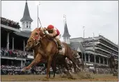  ?? JEFF ROBERSON — THE ASSOCIATED PRESS, FILE ?? Rich Strike, with Sonny Leon aboard, crosses the finish line to win the 148th running of the Kentucky Derby at Churchill Downs on May 7 in Louisville, Ky.