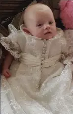  ??  ?? Baby April in the chirstenin­g robe made from her Mum’s wedding dress.