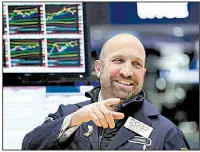  ?? AP/RICHARD DREW ?? on the floor of the New York Stock Exchange on Monday, when stocks rallied and the market clawed back some of its big losses from last week. The Dow Jones industrial average climbed 410 points.