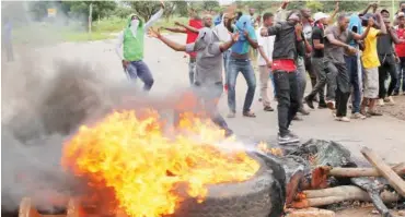  ?? PHOTO: ?? A protest in January on a road leading to Harare. The military was deployed in January to dispel protests against a fuel price hike. Philimon Bulawayo/Reuters