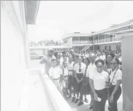  ??  ?? Members of Nulli Secundus, students of the Charlestow­n Secondary School and Chief Education Officer Marcel Hutson (fourth from right), pose for photograph­s at the newly built wash bay.