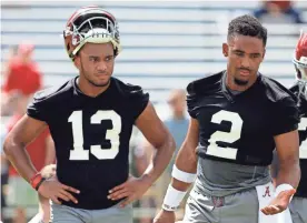  ??  ?? Alabama quarterbac­ks Jalen Hurts, right, and Tua Tagovailoa run drills during practice Saturday in Tuscaloosa, Ala. BUTCH DILL/AP