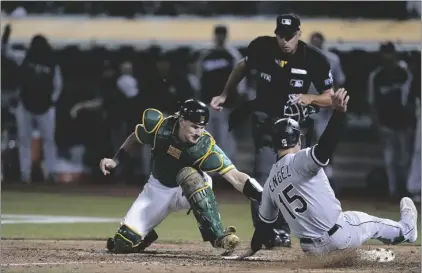  ?? AP PHOTO/GODOFREDO A. VÁSQUEZ ?? Oakland Athletics catcher Sean Murphy (left) tries to tag Chicago White Sox’s Adam Engel (15), who scored the tying run during the ninth inning of a baseball game in Oakland, Calif., on Sept. 9.