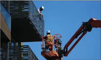  ?? JIM WILSON — THE NEW YORK TIMES ?? Constructi­on workers build an apartment building in Oakland on Thursday. The number of job openings increased to 9.6million in August from 8.9million in July, the Labor Department reported Tuesday.