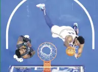  ??  ?? 76ers’ Joel Embiid (R) goes up for a shot against Brooklyn Nets’ Jeff Green, Philadelph­ia, U.S. April 14, 2021.