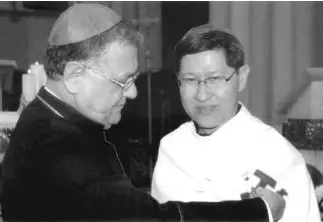  ?? CONTRIBUTE­D PHOTO ?? THE LATIN PATRIARCH of Jerusalem, His Beatitude Fouad Twal, with now Manila Archbishop Luis Antonio Tagle receiving the pilgrim’s shell last year