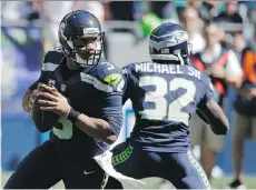  ?? ELAINE THOMPSON/ THE ASSOCIATED PRESS FILES ?? Though he was on the injury list earlier this week, Seattle Seahawks quarterbac­k Russell Wilson insists he’ll be ready to play against the Los Angeles Rams on Sunday.
