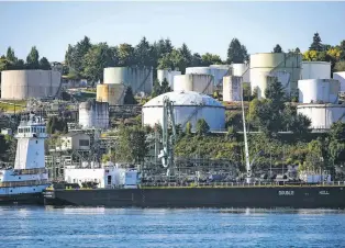  ?? DARRYL DYCK/BLOOMBERG NEWS ?? A double-hulled tanker sits docked in front of the Burnaby Refinery, near Vancouver. Natural gas is a key resource that covers the city’s energy use something Canada wants to transition away from.