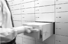  ??  ?? An employee checks a safe box at the vault of Swiss UBS bank in Zurich-Zollikon. Switzerlan­d’s private banks, used for decades by the world’s wealthy to hide money and avoid tax, are pushing for extra legal protection of client informatio­n that could...