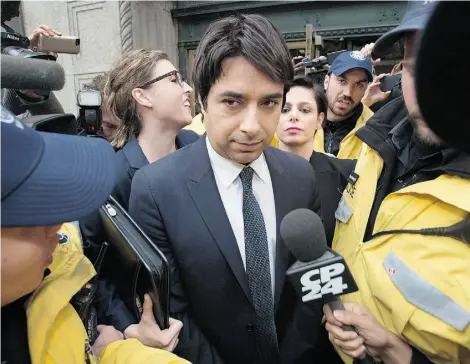  ?? DARREN CALABRESE/THE CANADIAN PRESS/FILE ?? Jian Ghomeshi is escorted from court in November 2014. On Tuesday, prosecutor­s withdrew two of eight charges filed against the former CBC Radio host. The dropped charges relate to alleged sexual assaults in Toronto and Owen Sound, Ont.