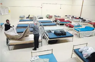  ?? CLIFFORD SKARSTEDT/EXAMINER FILE PHOTO ?? Beds are set up at the temporary location of Brock Mission at St. Paul's Presbyteri­an Church in this 2016 photo. A local doctor has called on city council to increase its funding to support homeless and marginaliz­ed people.