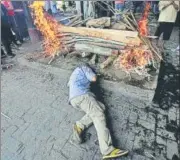  ?? REUTERS PHOTO ?? A man breaks down on Saturday at the funeral pyre of a relative who died in the train tragedy.