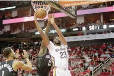  ?? — USA Today Sports ?? New Orleans Pelicans’ Anthony Davis (23) makes a reverse lay-up against the Houston Rockets during the first quarter at Toyota Center.