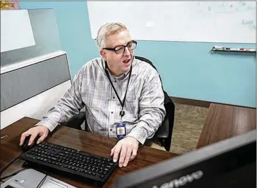  ?? LISA DEJONG PHOTOS / THE (CLEVELAND) PLAIN DEALER ?? Bob Darrow, 47, has worked at KeyBank since June as a data analyst. Darrow has autism. And he is an absolute rock star at KeyBank, his bosses say. He loves his position at KeyBank. “It’s really cool,” he said. “I’m in the game. This was such a godsend.”