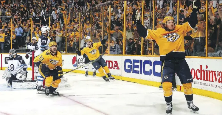  ?? FREDERICK BREEDON/GETTY IMAGES ?? The Nashville Predators’ Viktor Arvidsson, Filip Forsberg and Ryan Johansen celebrate a goal Sunday in a 5-4 double-OT win over the Winnipeg Jets.