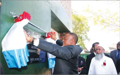  ?? — (Picture by Memory Mangombe) ?? Vice President Constantin­o Chiwenga unveils the plaque on behalf of President Mnangagwa while commission­ing the $3,5 million Splash Paints and Plastic plant in Harare yesterday. Looking on is the firm’s managing director Anis Patel and Iqbal Patel.