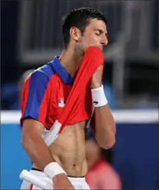  ?? Clive Brunskill/Getty Images ?? Novak Djokovic shows his frustratio­n after losing to Alexander Zverev in the semifinals Friday in Tokyo.