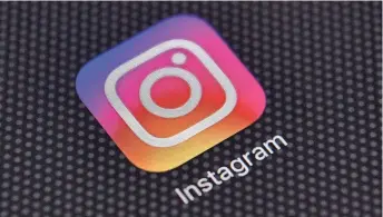  ?? CARL COURT/GETTY IMAGES ?? The Instagram app logo is shown on an iPhone.