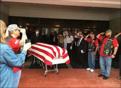  ?? PHOTOS BY RICHARD PAYERCHIN — THE MORNING JOURNAL ?? Veterans salute the casket of Samuel L. Felton Jr., 70, of Lorain, who died suddenly May 23. The Lorain Palace Theater held a visitation service for Felton and his family on May 29.