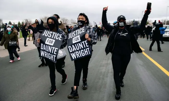  ?? Photograph: Chris Tuite/ImageSPACE/Rex/Shuttersto­ck ?? Protesters carrying ‘Justice for Daunte Wright’ signs march near the Brooklyn Center police department on 13 April.